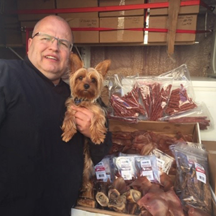 Dave and Joey, his Yorkie, with several products sold at Pet Planet.